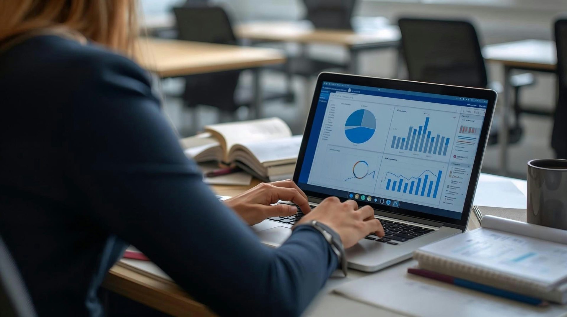 Woman working on laptop with charts and graphs
