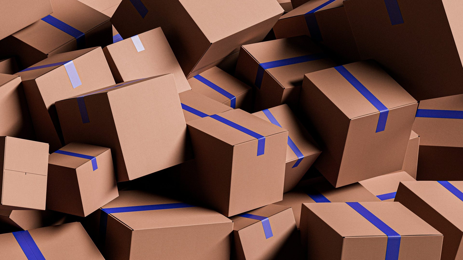 A large pile of brown cardboard boxes with blue tape